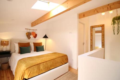 a white bedroom with a bed and a tub at Cantinho Da Lapa in Porto