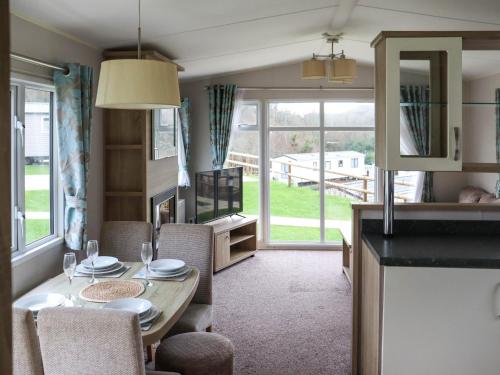 a kitchen and dining room with a table and chairs at Birch 2 - Ukc8215 in Pendine