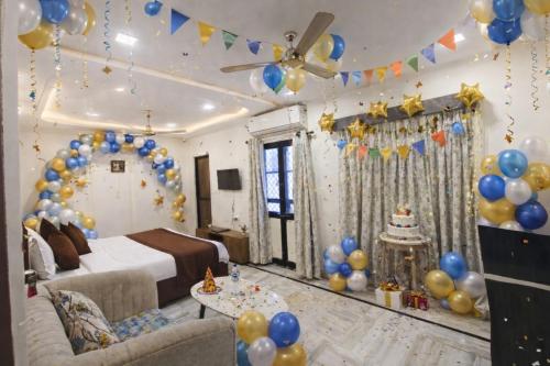 a room with a bed and a bunch of balloons at Holiday Out hotel in Jodhpur