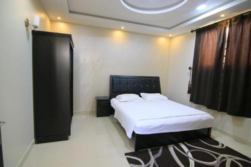 מיטה או מיטות בחדר ב-Danat Alnakheel Chalet