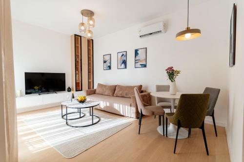 a living room with a couch and a table at Vrtovi Boke by Montena in Dobrota