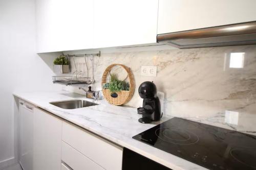 a kitchen with a sink and a counter top at Cantinho Da Lapa in Porto