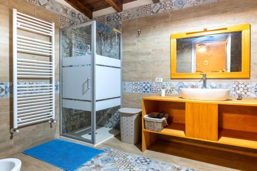 a bathroom with a sink and a shower at B&B Le Carrube in Sava