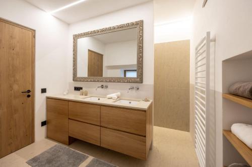 a bathroom with a sink and a mirror at Suite Lazzeri in Cortaccia