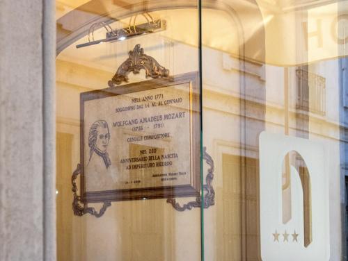 a sign in a window with a picture of a man at Hotel Antica Dogana in Turin
