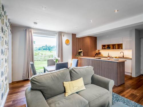 a living room with a couch and a kitchen at North Star Apartment - Uk3446 in Greenhaugh