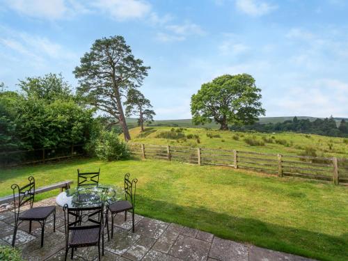 a patio with a glass table and chairs and a field at North Star Apartment - Uk3446 in Greenhaugh