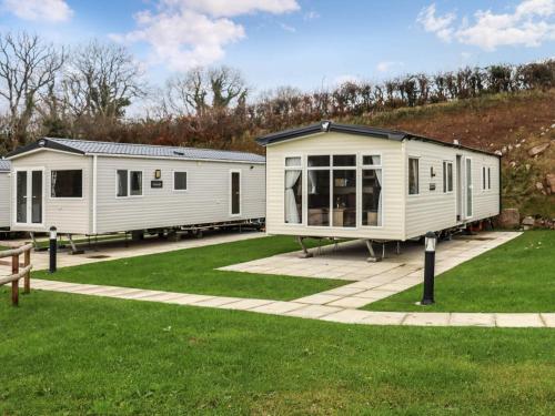 two mobile homes are parked in a park at Birch 3 - Ukc8216 in Pendine