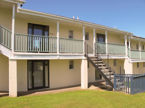 an exterior view of a building with a staircase at Holly Apartment - Uk49299 in Woolfardisworthy