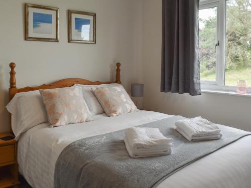 a bedroom with a bed with two towels on it at Sycamore Apartment - Uk49305 in Woolfardisworthy