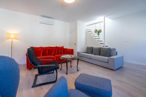a living room with a couch and a table and chairs at Les Variétés in La-Roche-en-Ardenne