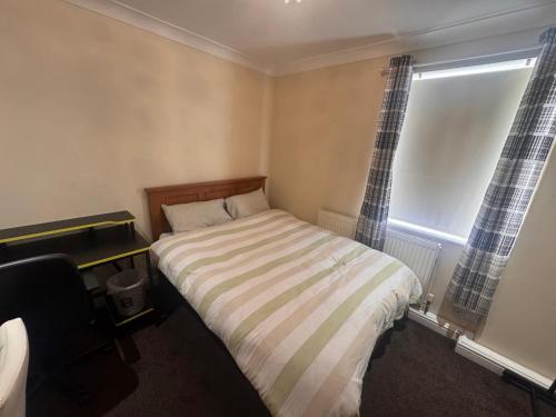 a small bedroom with a bed and a window at Home from Home 1 in Castleford