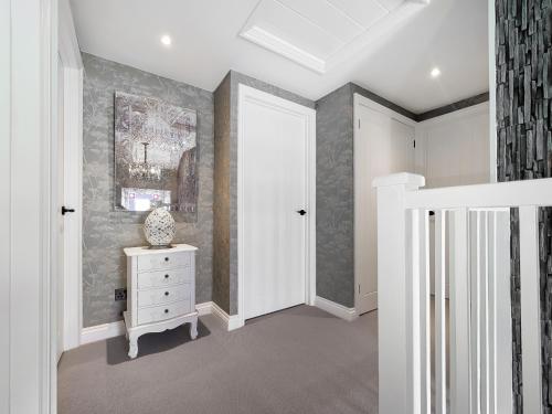 a room with a hallway with a dresser and a door at Mill House - Uk50646 in Falmouth