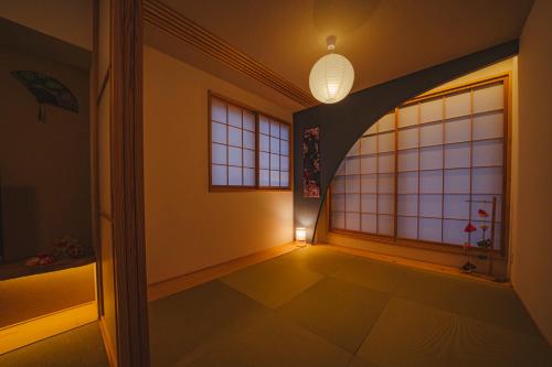 an empty hallway with a window and a light at ヒカリとテラス in Nagano