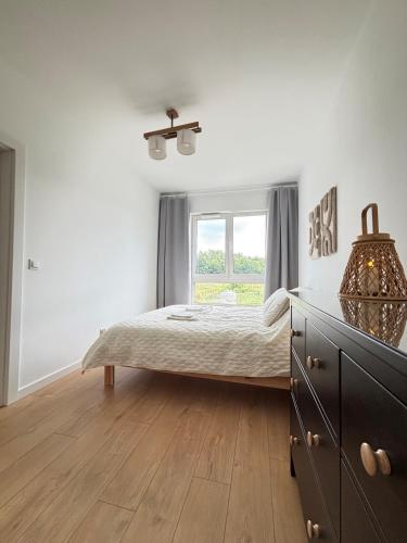 a bedroom with a bed and a window at Marigold Apartment Łódź in Łódź