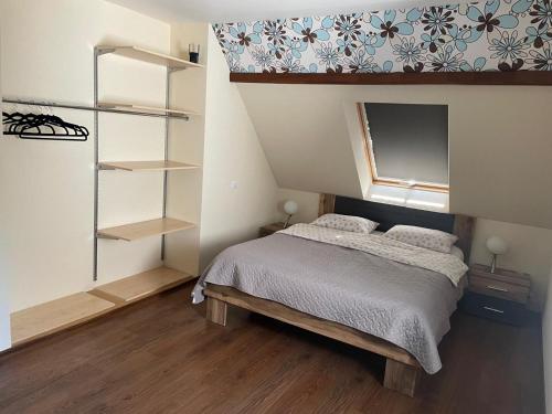 a bedroom with a bed and a book shelf at Svetes house - Garden & BBQ & Parking in Liepāja