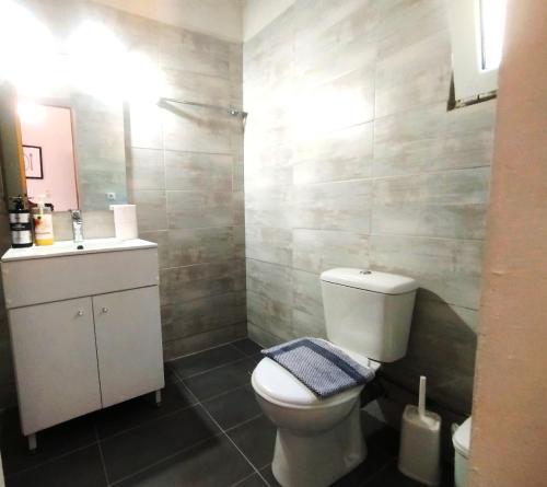 a bathroom with a toilet and a sink at Sarantakis Apartments in Agios Andreas