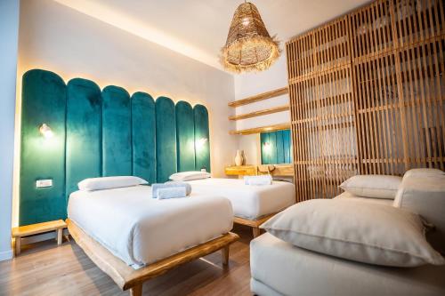 two beds in a room with green walls at Enjoy Palasa Comfy Villas in Palasë