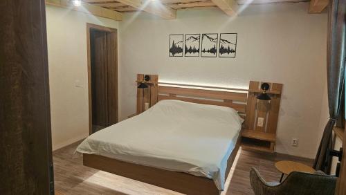 a bedroom with a white bed in a room at Cabana Valea Brândușelor in Bran