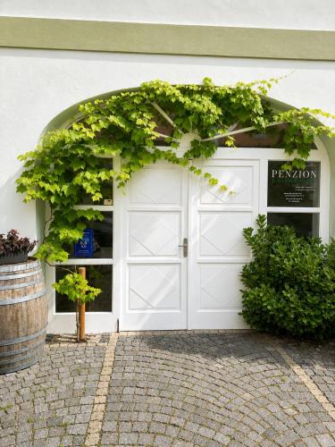 a white garage door with a wreath on it at Zelena Ratolest in České Budějovice