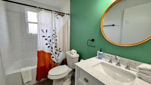 a bathroom with a toilet and a sink and a mirror at Meadow Sunrise in Bridgman