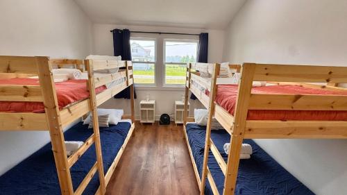a room with three bunk beds and a window at Meadow Sunrise in Bridgman