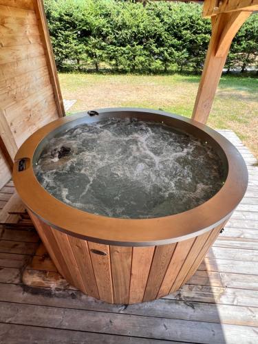 a circular hot tub on a wooden deck at Chalet Isabelle Mountain lodge 5 stars 6 bedroom en suite sauna spa inox in Chamonix