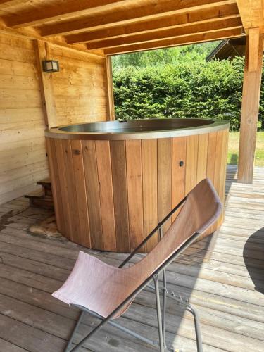 a chair sitting in front of a hot tub on a deck at Chalet Isabelle Mountain lodge 5 stars 6 bedroom en suite sauna spa inox in Chamonix