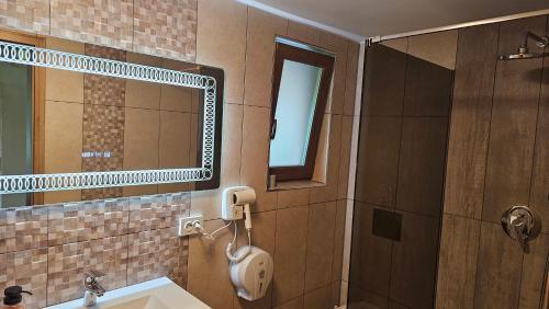 a bathroom with a sink and a mirror at Cabana Valea Brândușelor in Bran