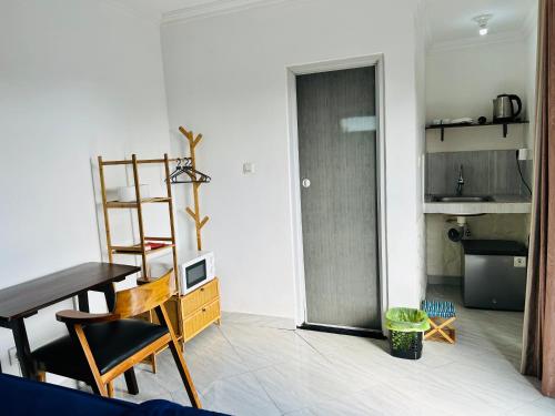 a living room with a table and chairs and a kitchen at Devata 68 Private Room VIP in Uluwatu
