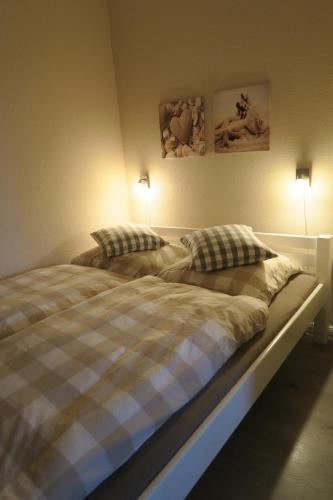 a bedroom with a bed with two pillows on it at Ferienwohnung Glockenberg - Westphal in Altenau