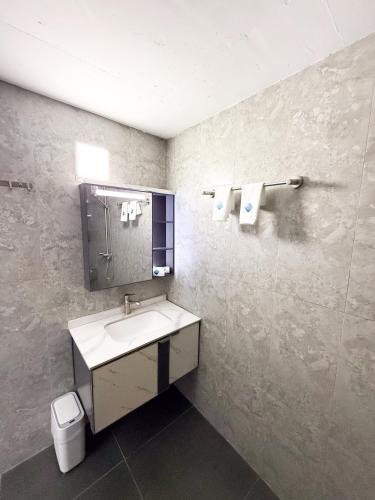 a bathroom with a sink and a mirror at Feeali Buddies Inn in Maldive Islands