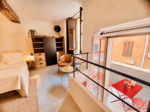 a room with a balcony with a couch and a table at Cabris Village Escape - Junior Suite in Cabris