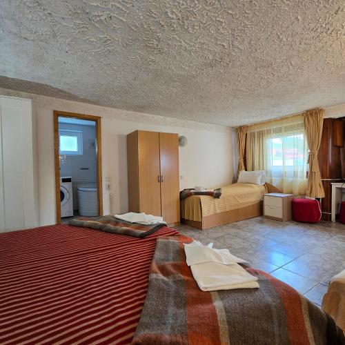 a hotel room with two beds and a bedroom at Apartament de vacanta Criss in Buşteni