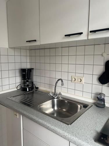 a kitchen counter with a sink and a coffee maker at Fernblick Oase in Meschede
