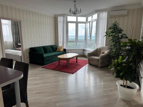 a living room with a couch and a table at Apartments with Dnipro view in Kyiv