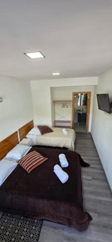 a bedroom with two beds with towels on them at Residencial Hospedaria Vale do Rodo in Peso da Régua