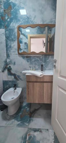 a bathroom with a sink and a mirror at Residencial Hospedaria Vale do Rodo in Peso da Régua