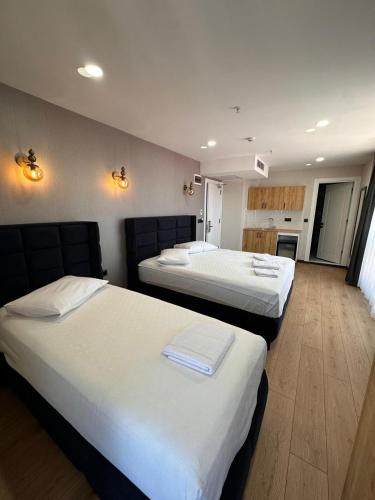 a hotel room with two beds and a kitchen at Dream Hotel in Trabzon