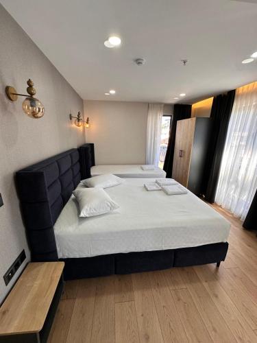 a bedroom with a large bed with a black headboard at Dream Hotel in Trabzon