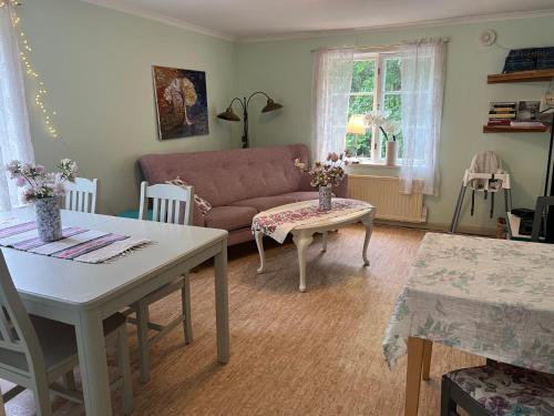 a living room with a couch and a table at Stora Djulö Vandrarhem in Katrineholm