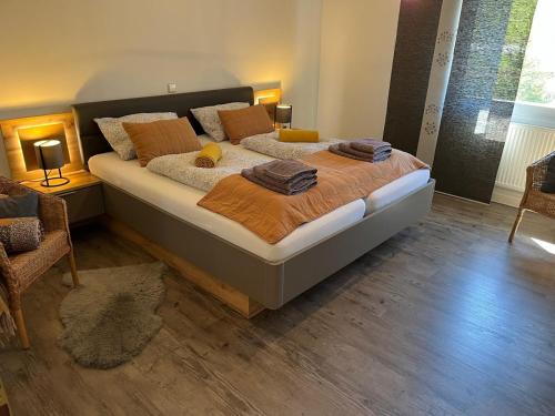 a bedroom with a large bed in a room at Ferienhaus Bibernest in Münsingen