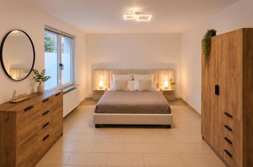 a bedroom with a bed and a large mirror at Arcade Apartment Bad Oldesloe in Bad Oldesloe