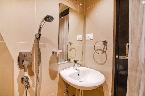 a bathroom with a sink and a shower at J P Guest House in Howrah
