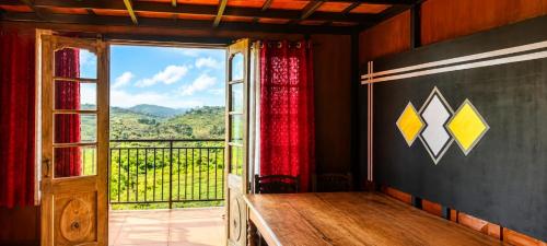 a room with a window and a view of a mountain at Kalathil Guest House in Vagamon