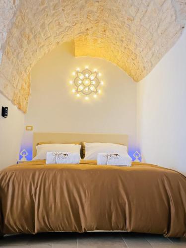 a bedroom with a large bed with a ceiling at Dimora Le Volte Ostuni in Ostuni