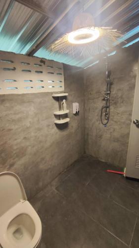 a bathroom with a toilet and a shower at Laena Homestay in Ko Yao Noi