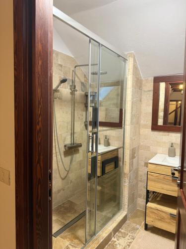 a glass shower in a bathroom with a sink at Ohaba 140-141 By Holztreppe in Ohaba
