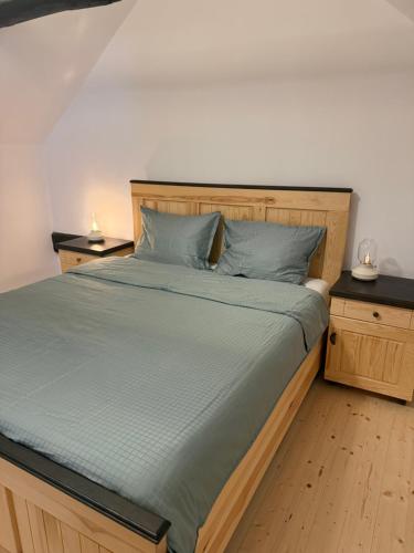 a bedroom with a large bed with blue pillows at Ohaba 140-141 By Holztreppe in Ohaba