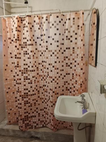 a bathroom with a sink and a shower curtain at Fabylu in Ezpeleta